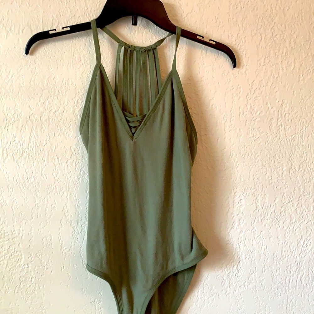 Never worn body suit with cute back design.